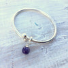 Amethyst Stability & Strength Bangle Bracelet by ZEN by Karen Moore on white wood