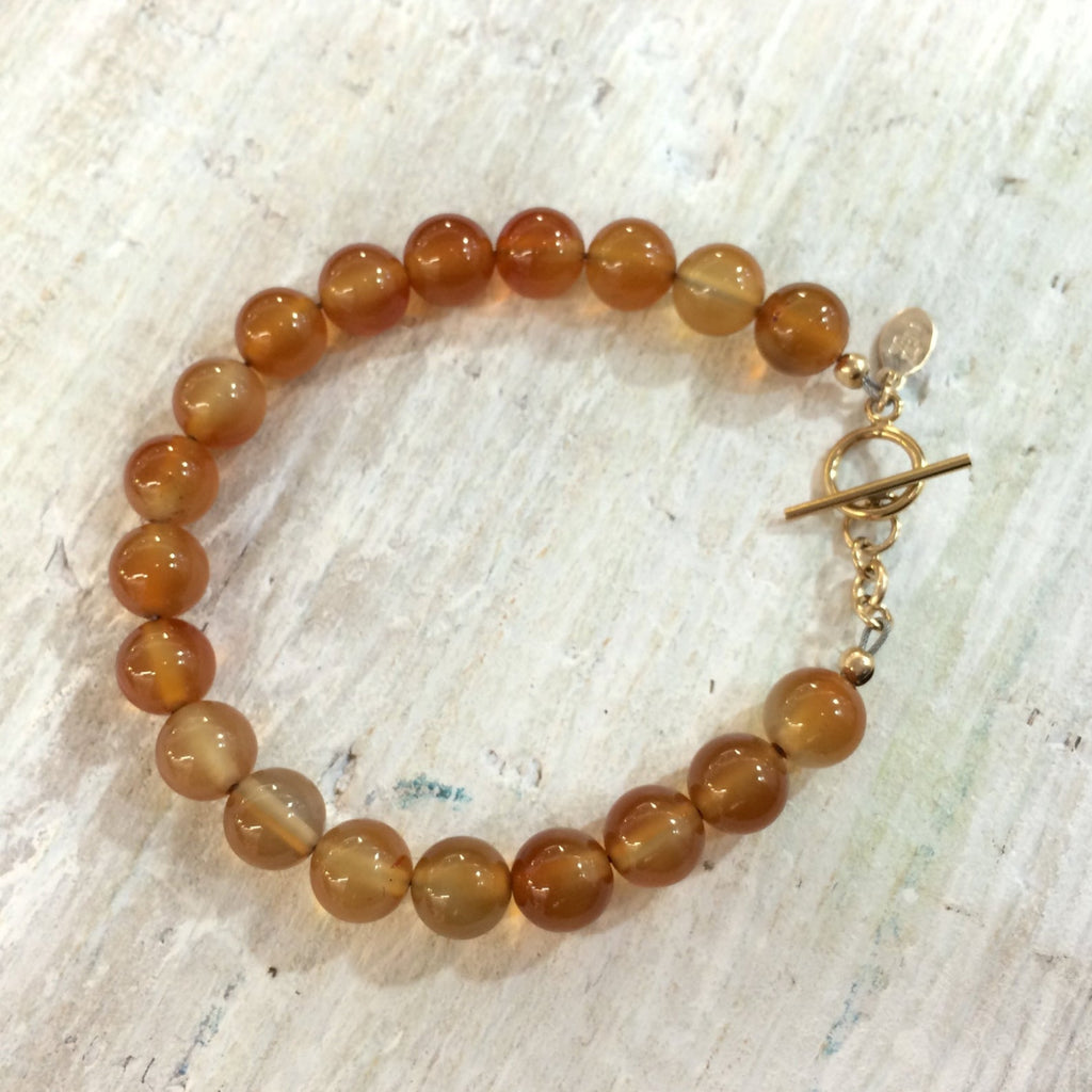 I Live With Passion Carnelian Bracelet by ZEN by Karen Moore Jewelry on white wood