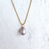 Island Love pearl necklace by ZEN by Karen Moore straight up-an-down view on white wood