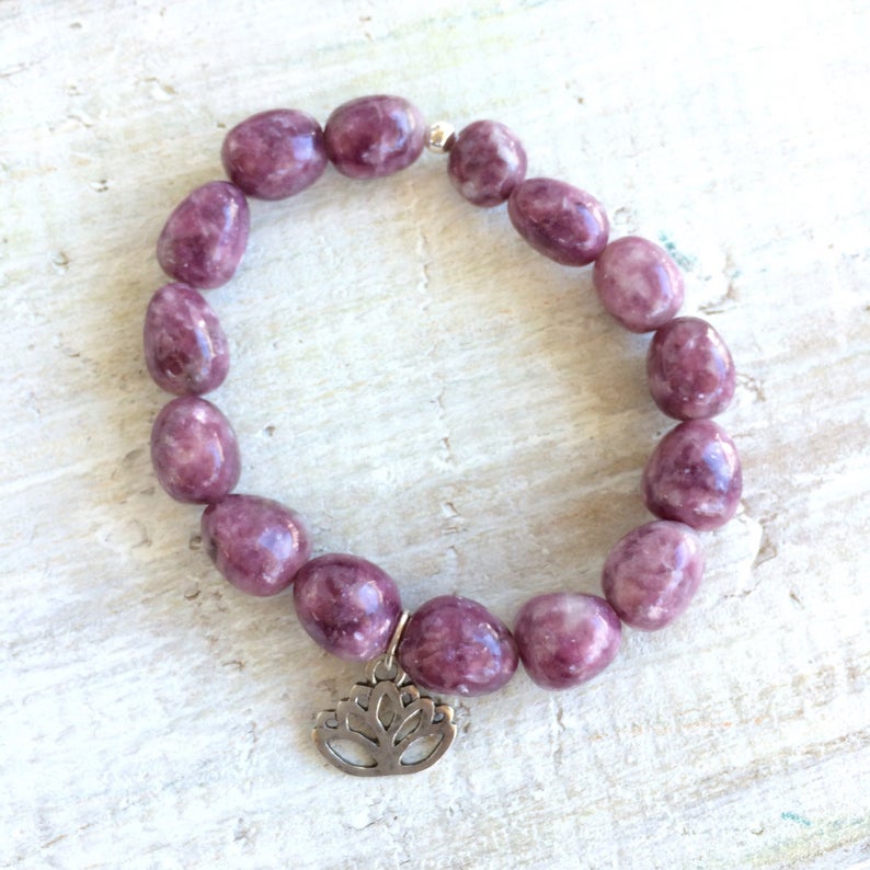 Let Go & Transform Lepidolite Bracelet by ZEN by Karen Moore overhead alternate view of lotus charm on white wood