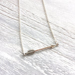 You're Going The Right Way Arrow Necklace in silver by ZEN by Karen Moore on white wood