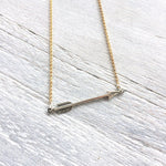You're Going The Right Way Arrow Necklace in gold & silver by ZEN by Karen Moore on white wood