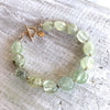 Reach Your Highest Potential prehnite bracelet by ZEN by Karen Moore angled view on white wood