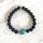 Rainbow obsidian & turquoise Rock Of Turquoise Bracelet by ZEN by Karen Moore overhead view on white wood