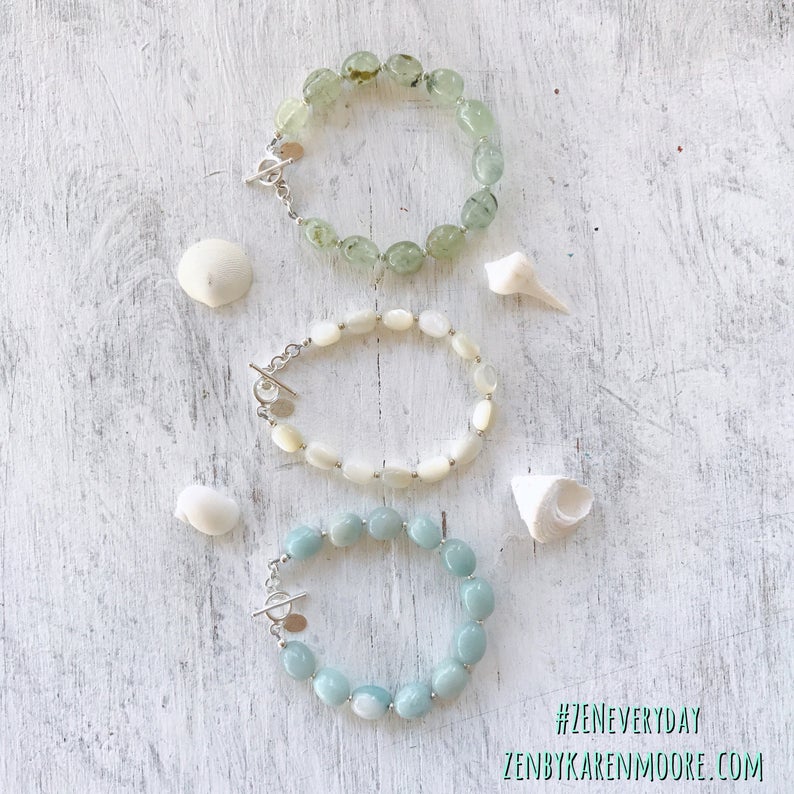 Amazonite Seas The Day Bracelet by ZEN by Karen Moore jewelry with two other gemstone bracelets with seashells on white wood