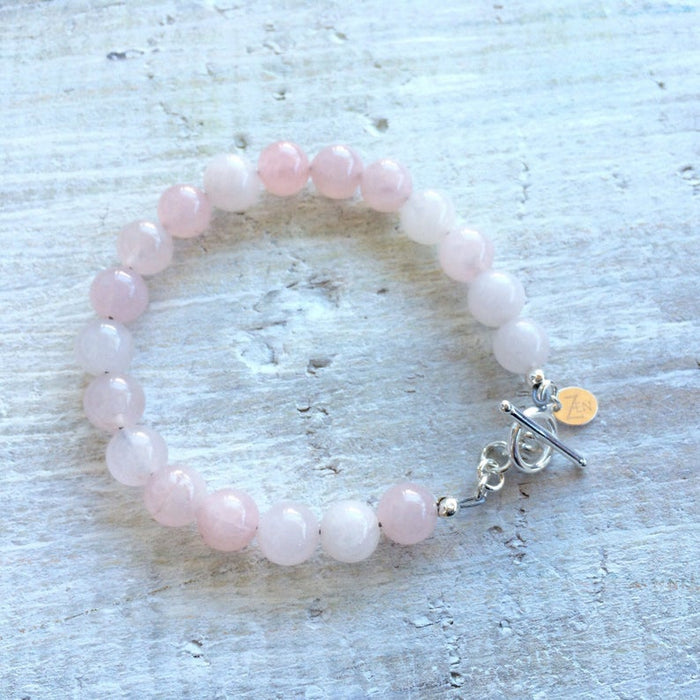 I Am Love rose quartz bracelet by ZEN by Karen Moore alternate view on white wood