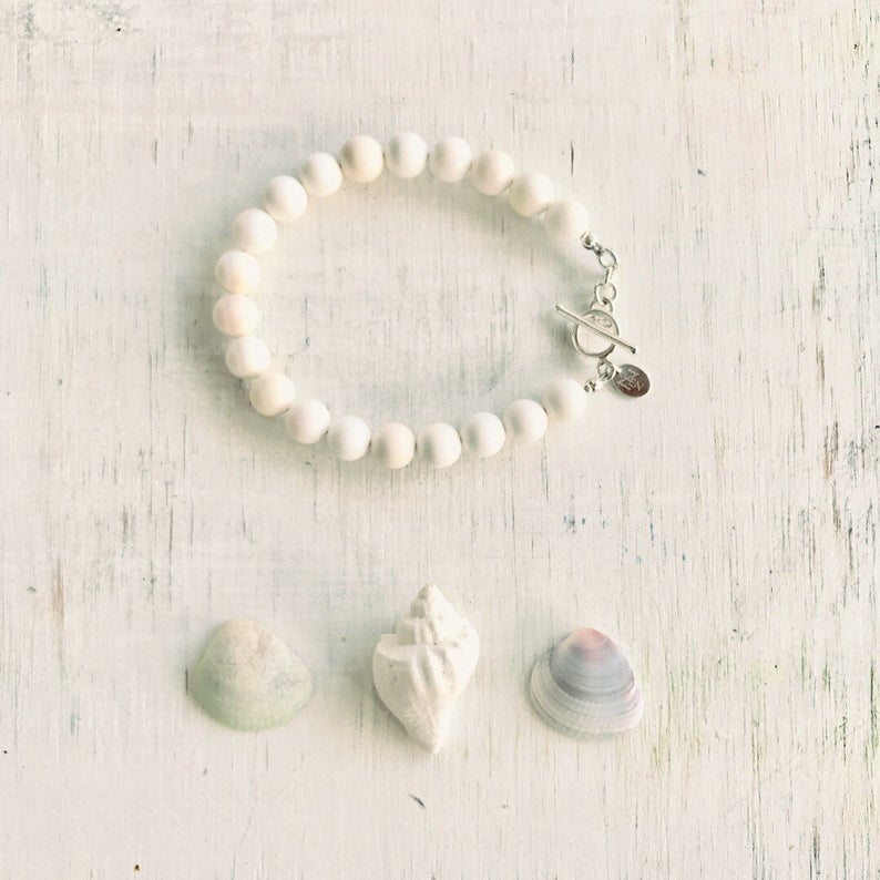 Purely Conch Bracelet by ZEN by Karen Moore jewelry with three seashells on white wood