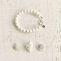 Purely Conch Bracelet by ZEN by Karen Moore jewelry with three seashells on white wood