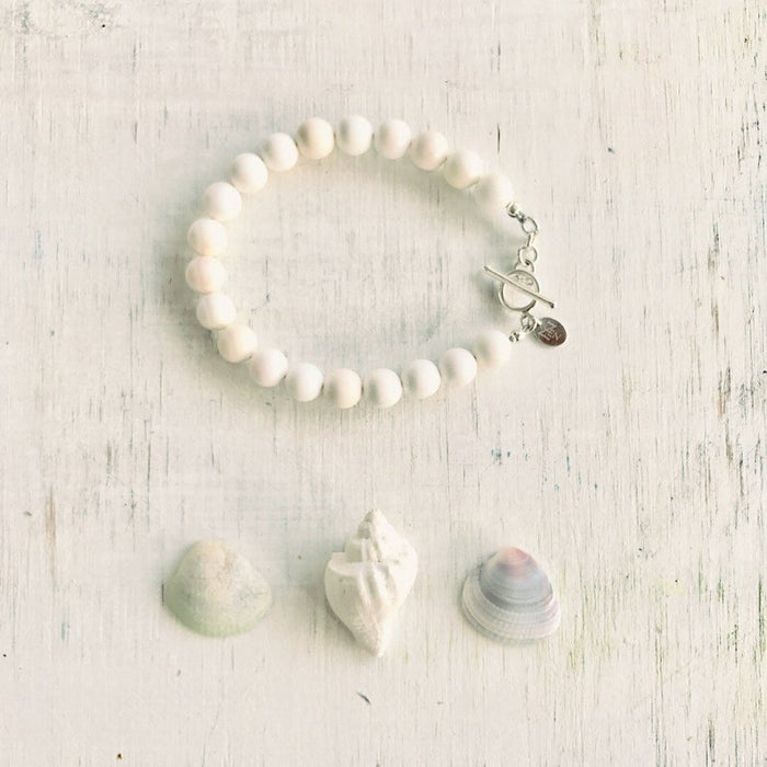 Purely Conch Bracelet by ZEN by Karen Moore jewelry with three seashells on white wood