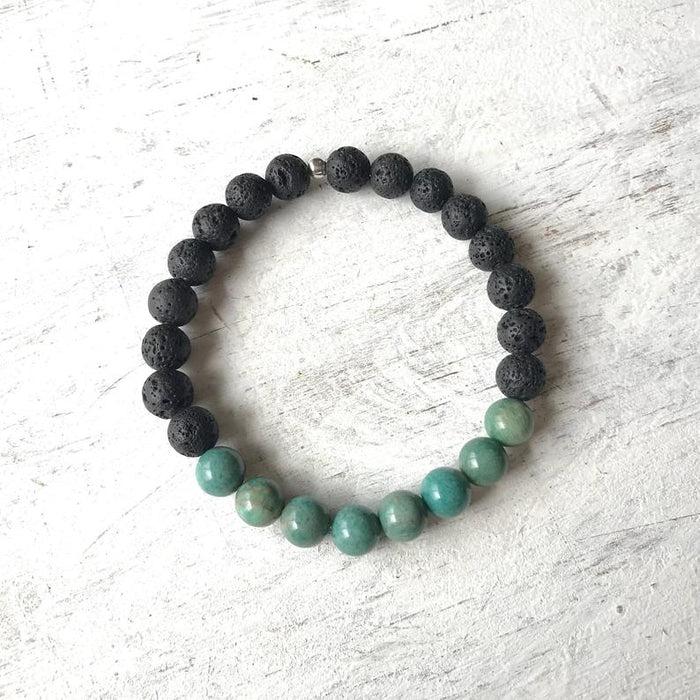 African turquoise & lava stone Be Healthy Aromatherapy Bracelet by ZEN by Karen Moore overhead view on white wood