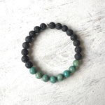 African turquoise & lava stone Be Healthy Aromatherapy Bracelet by ZEN by Karen Moore overhead view on white wood