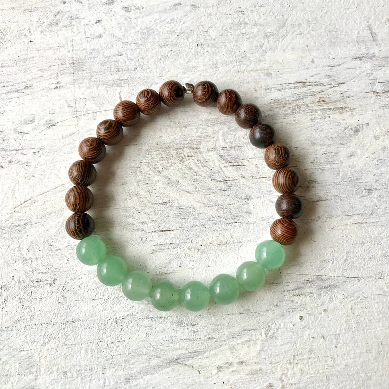 Bring On Wellness tiger wood and aventurine bracelet by ZEN by Karen Moore overhead view on white wood