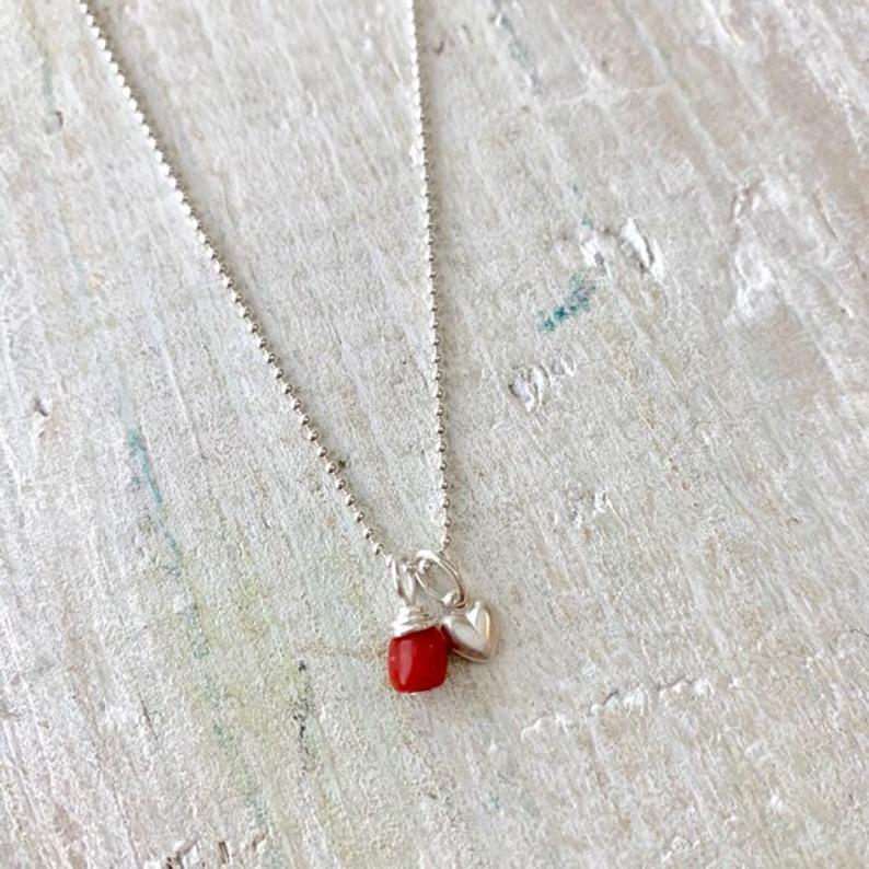 Little Lover Coral Charm Necklace by ZEN by Karen Moore on white wood