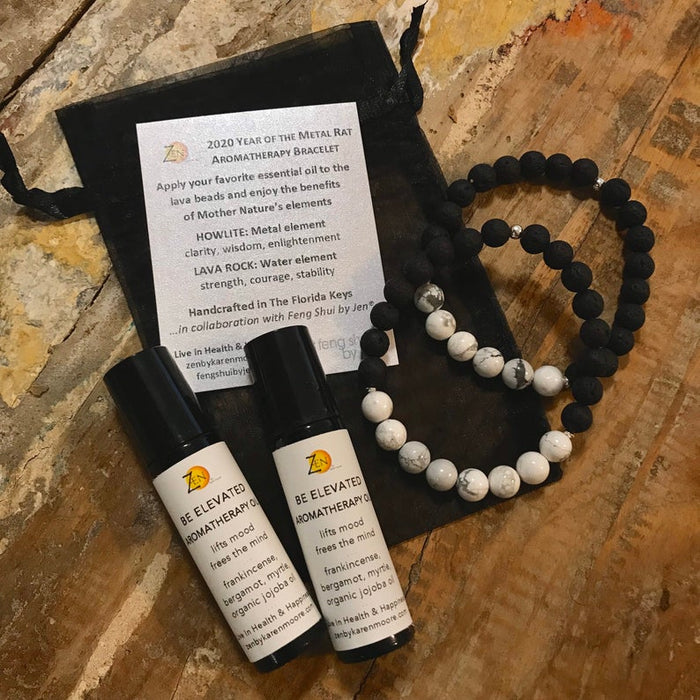 Frankincense, myrtle and bergamot BE Elevated Aromatherapy Essential Oil Roller Blend with aromatherapy bracelets, product card & gift pouch by ZEN by Karen Moore on wood background