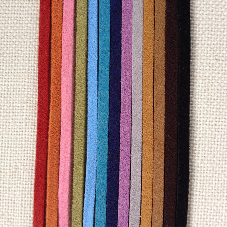 Rainbow of Eco ZEN Wrap jewelry suede bands on cream cloth
