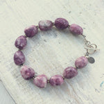 Let That Shit Go Lepidolite Bracelet with silver clasp by ZEN by Karen Moore on white wood