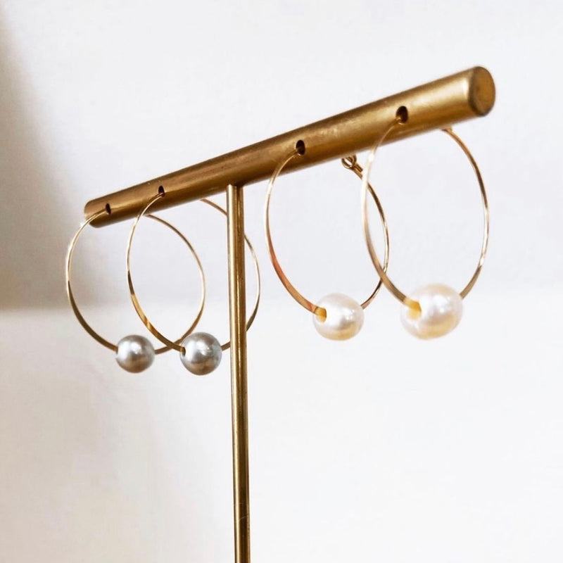 Circle of Wisdom Pearl Hoop Earrings 2 pairs hanging on display