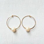 Circle of Wisdom Pearl Hoop Earrings 14kt gold on white background overhead view