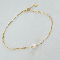 ZEN by Karen Moore Anchored in Clarity Conch Shell Anklet 14kt gold filled paperclip chain on white wood background