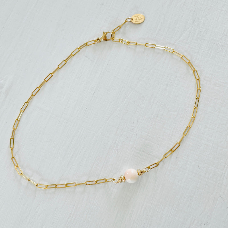 ZEN by Karen Moore Anchored in Clarity Conch Shell Anklet 14kt gold filled paperclip chain on white wood background