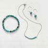Turquoise Smile Necklace by ZEN by Karen Moore with turquoise bracelet and earrings on white background