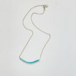 Turquoise Smile Necklace by ZEN by Karen Moore overhead view on white background