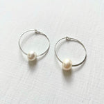 Circle of Wisdom Pearl Hoop Earrings sterling silver on white background angled view