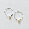 Circle of Wisdom Pearl Hoop Earrings sterling silver on white background overhead view